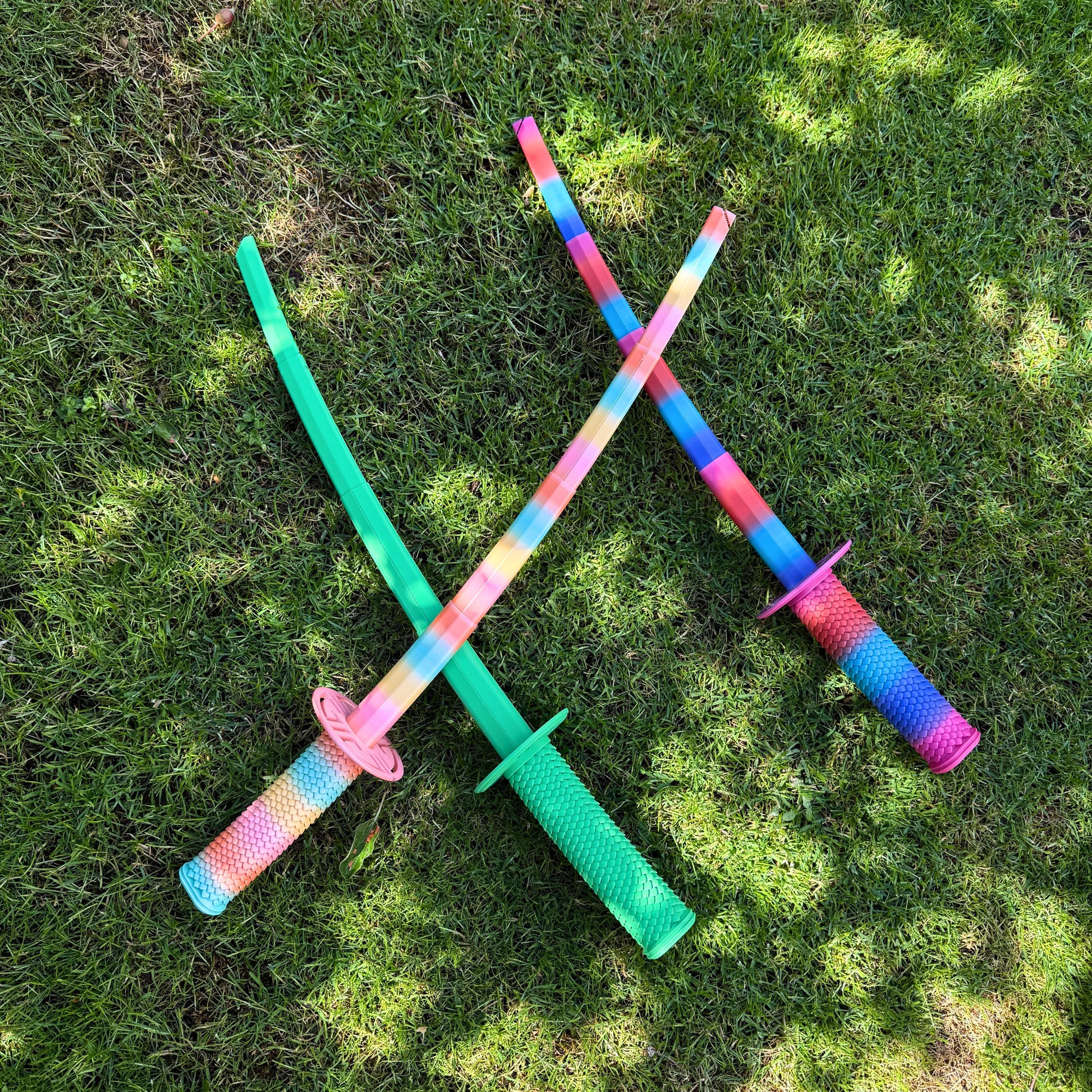 Zijaanzicht van de uitgeschoven 3D geprinte telescopische regenboog katana met drakenhuid handvat.