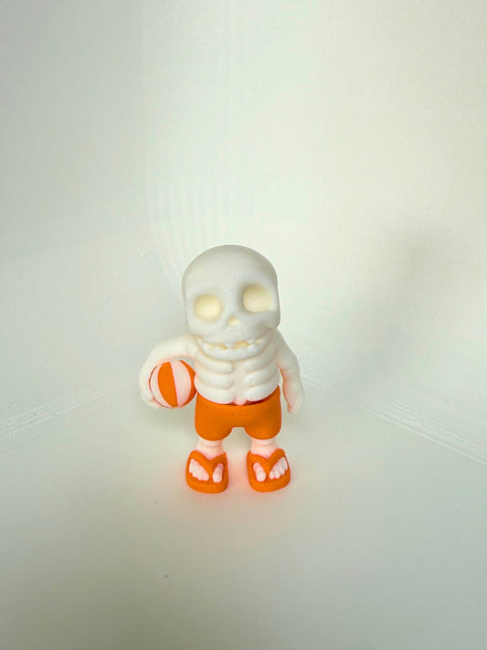 Articulated skeleton beach toy with orange shorts and sandals, perfect for summer fun – eco-friendly and child-safe